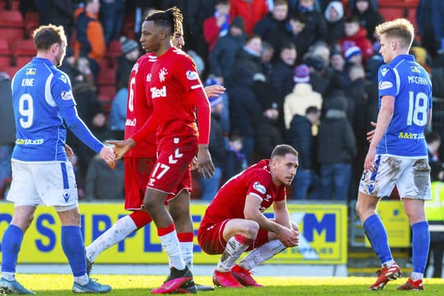 Nikola Katic, crouching, looks disappointed at full time. Picture: Rob Casey / SNS