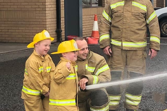 The pair try out being firemen. Picture: DSA